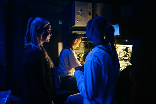 A shared smile beside the backstage control panel