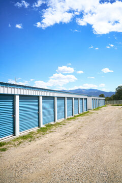 Row of blue storage units under blue sky
