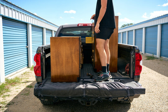 Unloading wooden dressers from a pickup truck