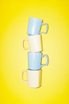 Assembly of pastel coloured light yellow blue ceramic coffee cups