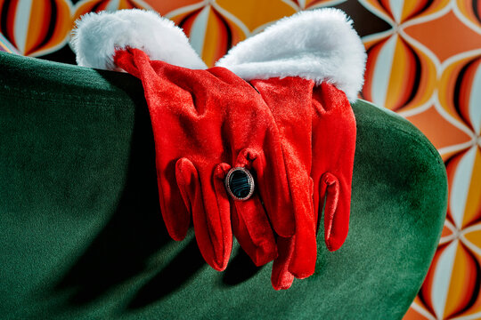close view of Santa gloves with white cuffs and a black stone ring